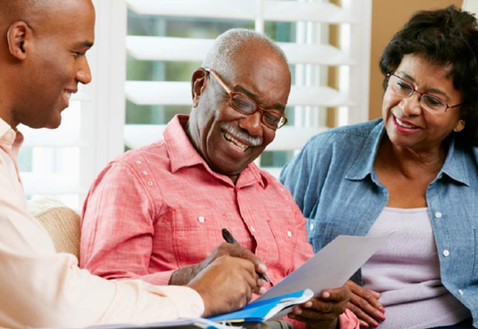 Older Veteran reviewing paperwork with family members