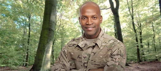 veteran standing in woodland area