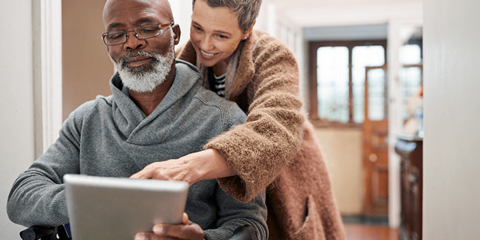 Volunteer helping veteran with a tablet