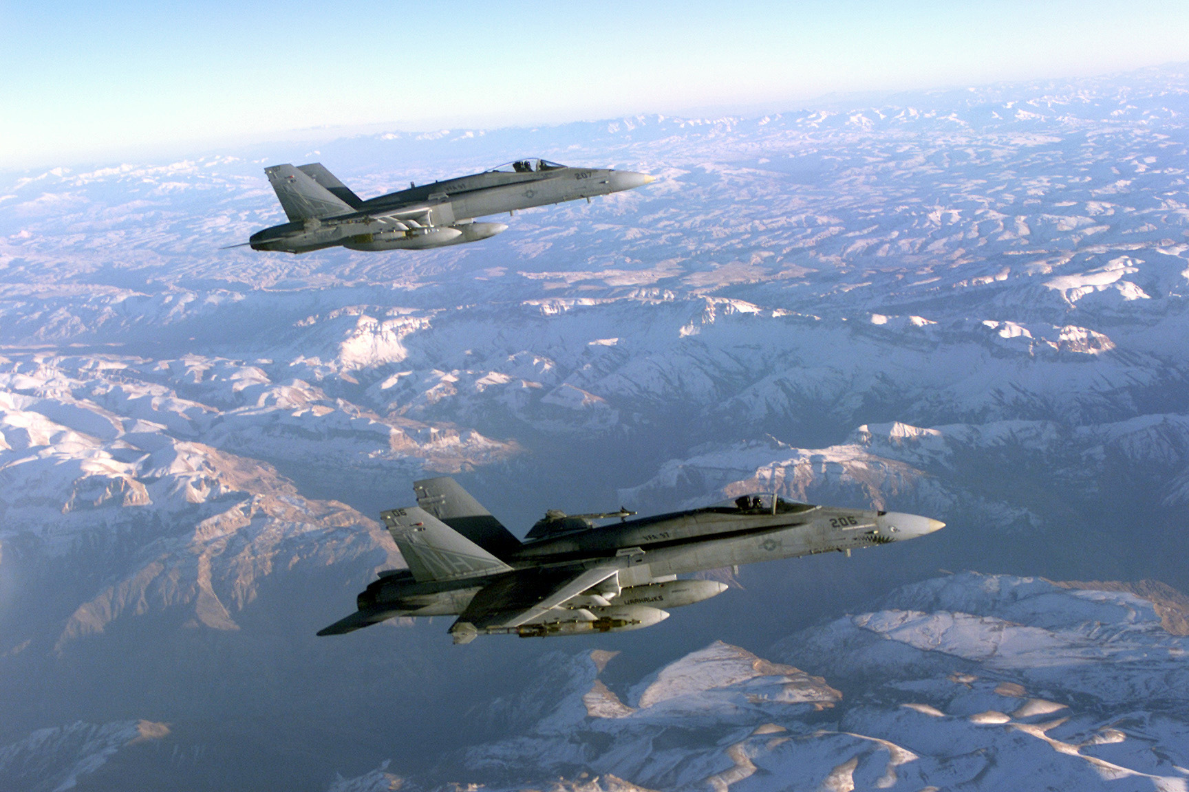 Two Navy F/A-18 Hornets patrol the skies over Afghanistan in support of Operation ENDURING FREEDOM. Both carry external fuel tanks and are armed with Paveway II laser guided GBU-16 1,000-pound bombs and AIM-9 Sidewinder missiles. In response to the terrorist attacks on September 11, 2001 at the New York World Trade Center and the Pentagon, President George W. Bush initiated Operation ENDURING FREEDOM in support of the Global War on Terrorism (GWOT), fighting terrorism abroad.
