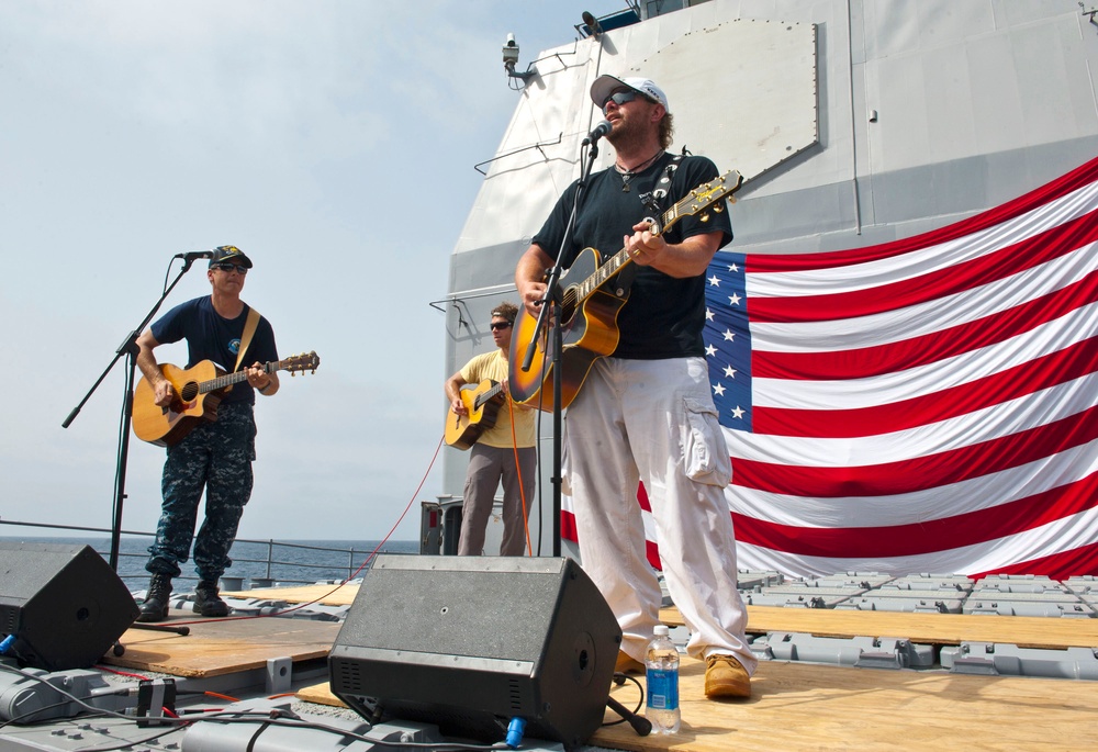 Capt. Don Gabrielson, left, commanding officer of the Ticonderoga-class guided-missile cruiser USS Cape St. George (CG 71), performs with country music singer Toby Keith during a USO performance aboard the ship. Keith is on his 10th tour with the USO, performing for deployed service members around the world. Cape St. George is deployed as part of the Abraham Lincoln Carrier Strike Group to the U.S. 5th Fleet area of responsibility conducting maritime security operations, theater security cooperation efforts and support missions as part of Operation Enduring Freedom.