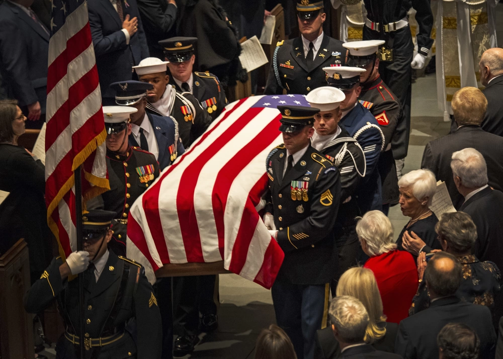 Service members from the ceremonial honor guard transport the casket of George H. W. Bush, 41st President of the United States, from the sanctuary at St. Martin’s Episcopal Church in Houston, December 6, 2018. Nearly 4,000 military and civilian personnel from across all branches of the U.S. armed forces, including Reserve and National Guard components, provided ceremonial support during the funeral.(DoD photo by U.S. Army Spc. Joseph Black)