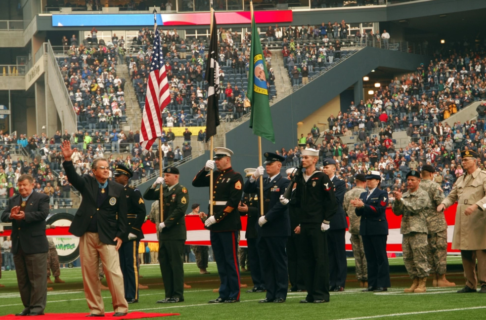The U.S. Military Sea Hawker Color Guard prepares to present colors after a recognition ceremony for congressional Medal of Honor veterans Col. Joe M. Jackson, left, and Maj. Gen. Patrick H. Brady at the Seattle's Qwest Field during the Seahawks annual Military Appreciation Day celebration.