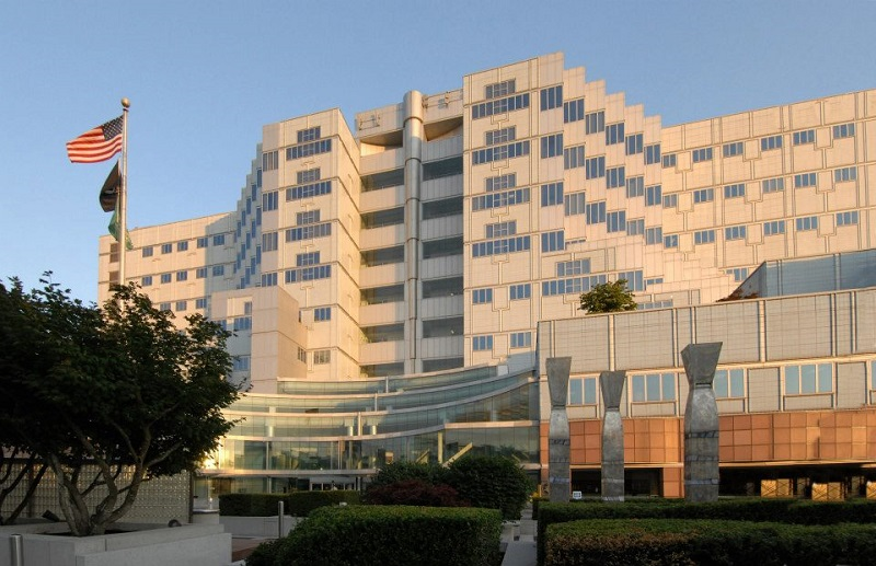 The Portland Veterans Affairs Medical Center campus sits on a 450-foot-tall basalt-rock hill south of downtown. In 1987, VA expanded PVAMC and built a skybridge with federal funding secured by Senator Mark Hatfield. The 660-foot-long skybridge allows direct transportation of patients and supplies between PVAMC and OHSU over a 150-foot-deep ravine.